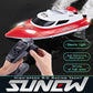 Red and white RC racing yacht with remote controller in hand, splashing water