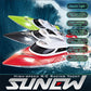 Green and white RC racing yacht on water with remote controller, splash wake
