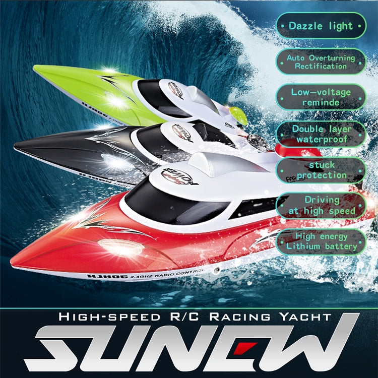 Green and white RC racing yacht on water with remote controller, splash wake