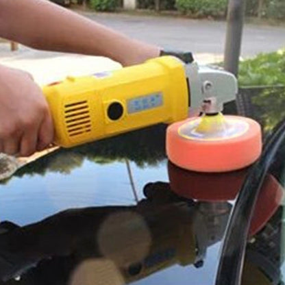 Car polishing foam pad mounted on auto polisher, with orange and red sponge wheel.