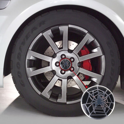 Round wheel hub center cover with black base and silver spider web design