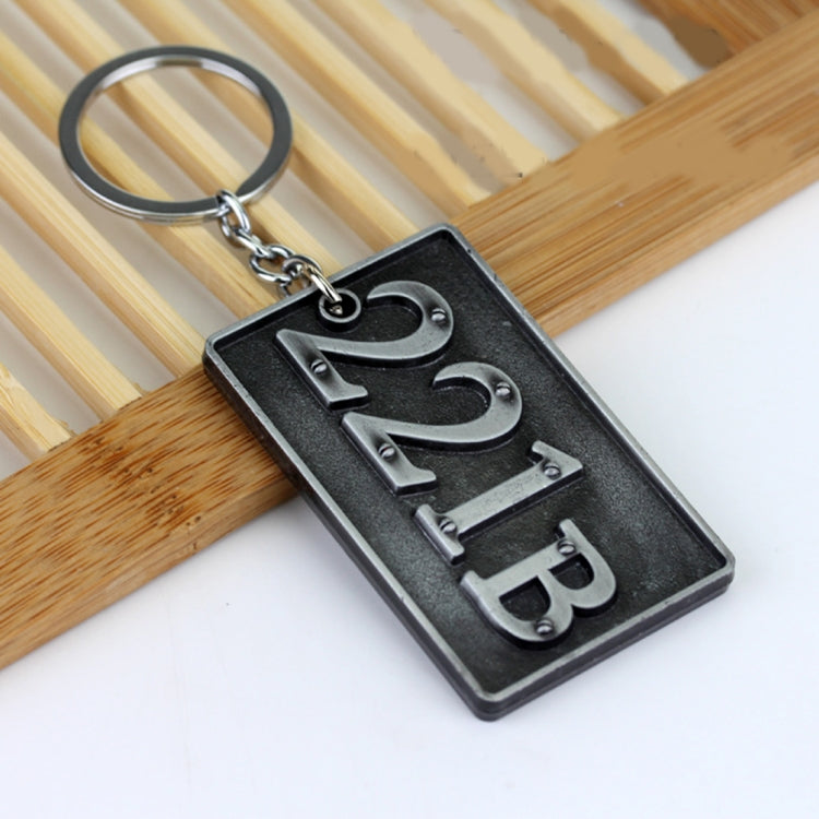 Metal keychain with dark rectangular 221B-style engraving and split-ring attachment