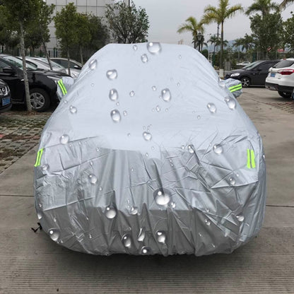 White SUV car cover with water droplets and neon green warning stripes