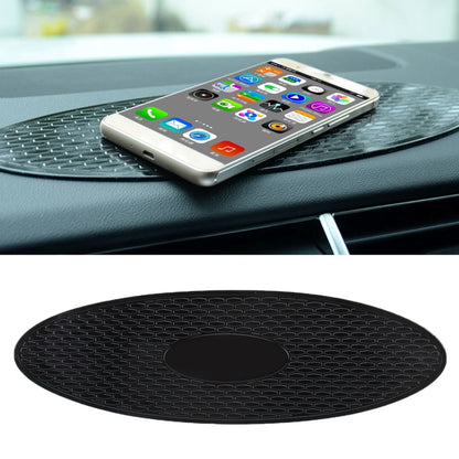 Oval anti-slip rubber dashboard mat with grippy pattern and phone resting on top
