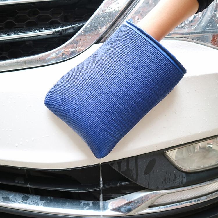 Blue car washer glove with thick cuff, held over a vehicle front for cleaning