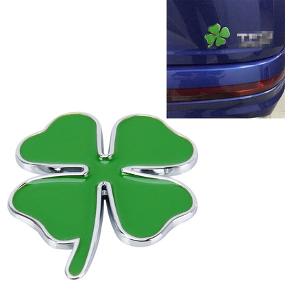 Four-leaf clover emblem sticker with green center and chrome outline, front view