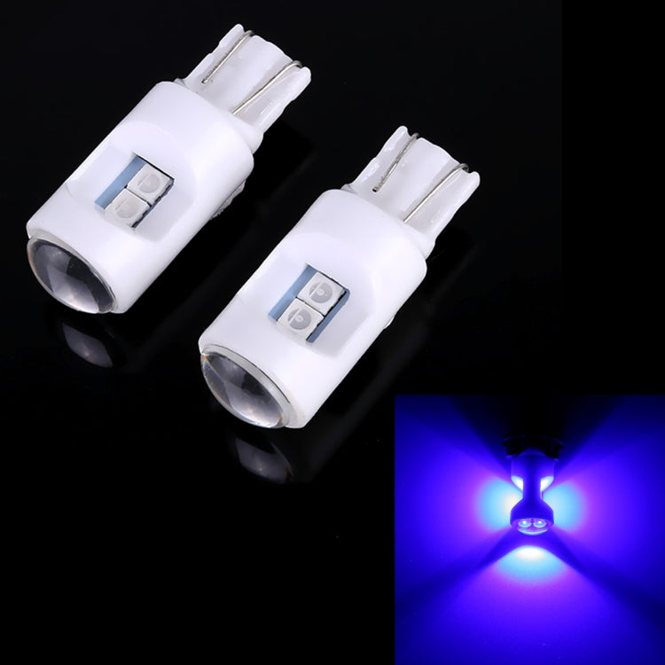 Pair of white T10 LED projector bulbs emitting ice-blue light glow