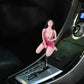 Car shift knob topper with brunette woman figure in magenta outfit on gear area