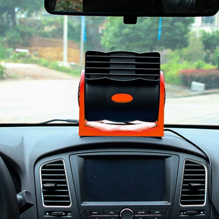 Portable vehicle cooling fan with front vent grille, orange oval panel, and base on pad