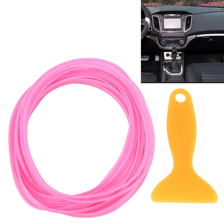 Pink flexible car interior trim strip coil with orange scraper tool