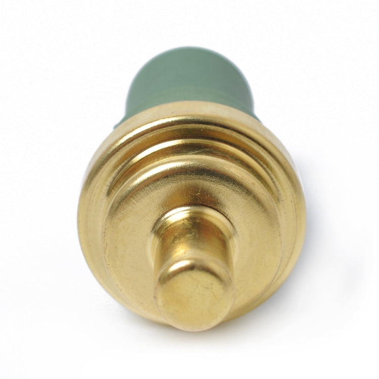 Coolant temperature sensor with gold face and green protective connector cap