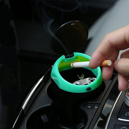 Portable car ashtray trash bin, green with lid open and cigarette inside