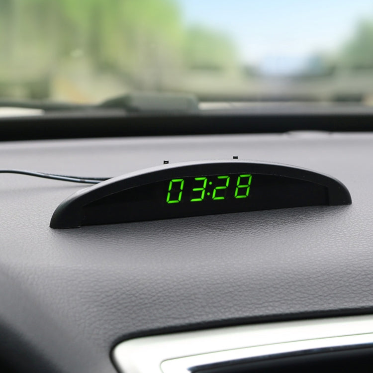 Car LED digital thermometer clock on dashboard with green LED reading 07:28