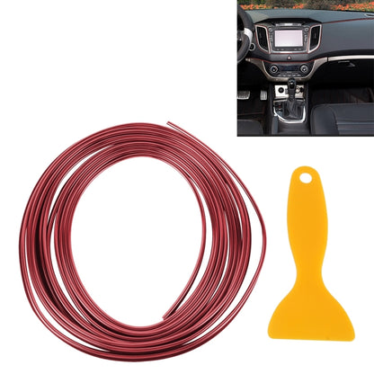 Red flexible car trim strip roll with yellow plastic scraper tool