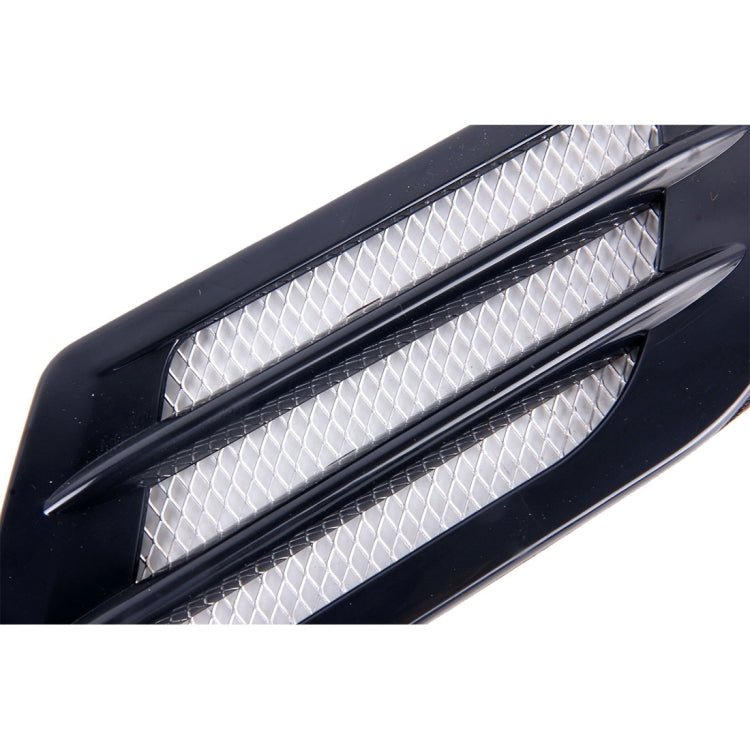 Black hood vent grille cover close-up, white diamond mesh with chrome-style trim