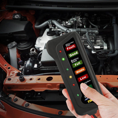 TIROL 12V battery alternator tester with LED display, held in hand over car engine bay
