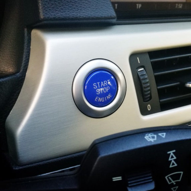 Blue start-stop engine button cover with chrome rim in BMW dashboard