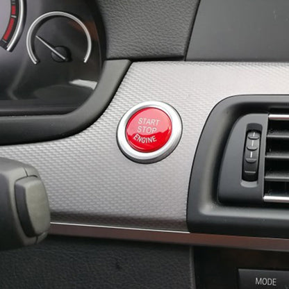 Red push-start engine button cover with chrome ring for car interior