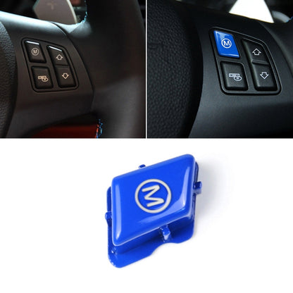 Blue M logo button switch trim cover on car steering wheel control panel