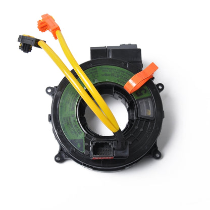 Clock spring cable assembly with yellow wires, orange clips, and black circular module