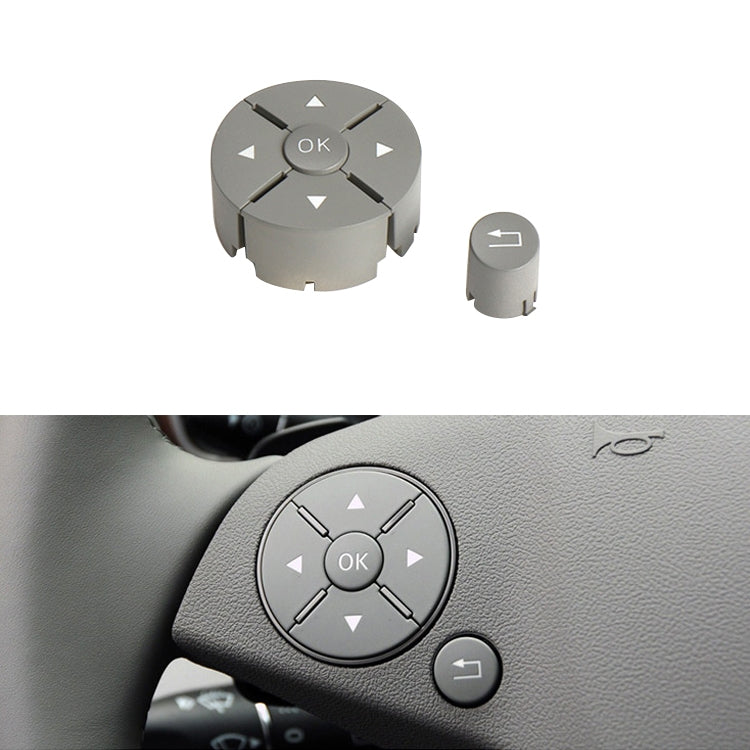 Grey steering wheel switch button panel with OK ring and arrow icons, left control