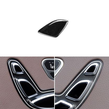Car seat headrest adjustment switch button on interior panel, black center with silver trim