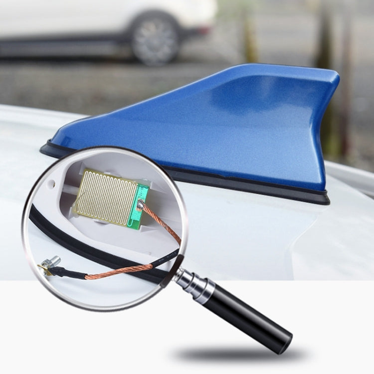 Blue shark-fin car antenna with circuit board insert shown