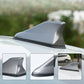 Shark fin car antenna aerial, gray fin mounted on car roof.
