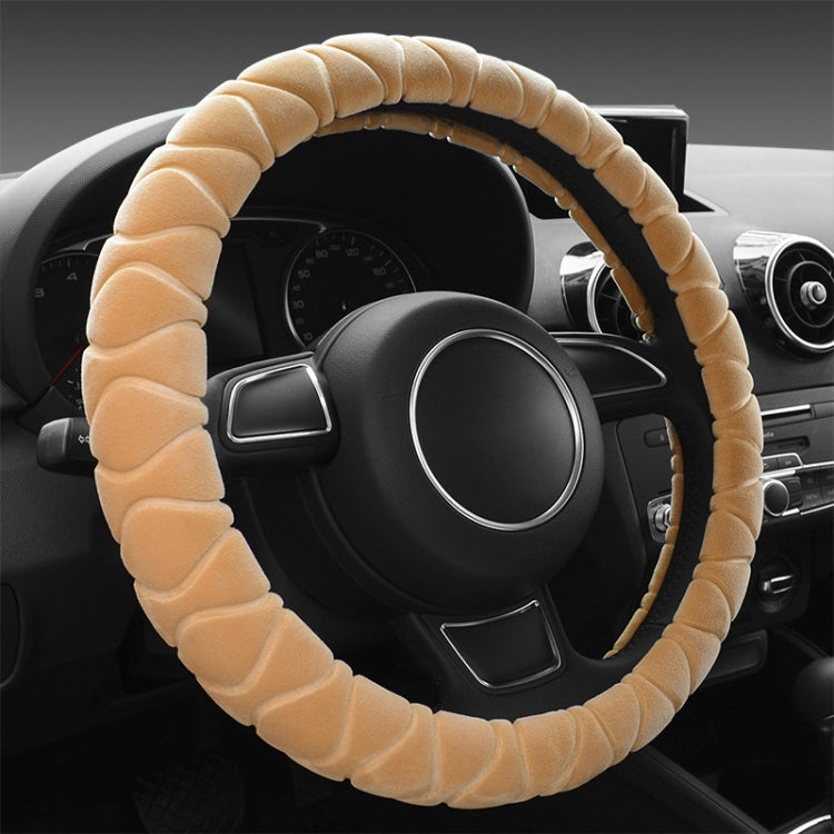 Beige plush steering wheel cover with ribbed texture, anti-slip grip.