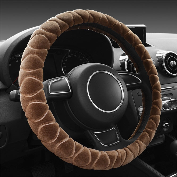 Brown plush steering wheel cover with ribbed texture, anti-slip grip.