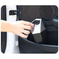 Hand using a mini push-lid trash can inside a car seat console