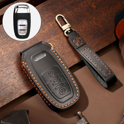 Black cowhide leather key fob cover with embossed emblem, orange stitching, metal key ring