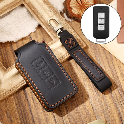Black leather key fob protective cover with embossed button icons and stitched edges