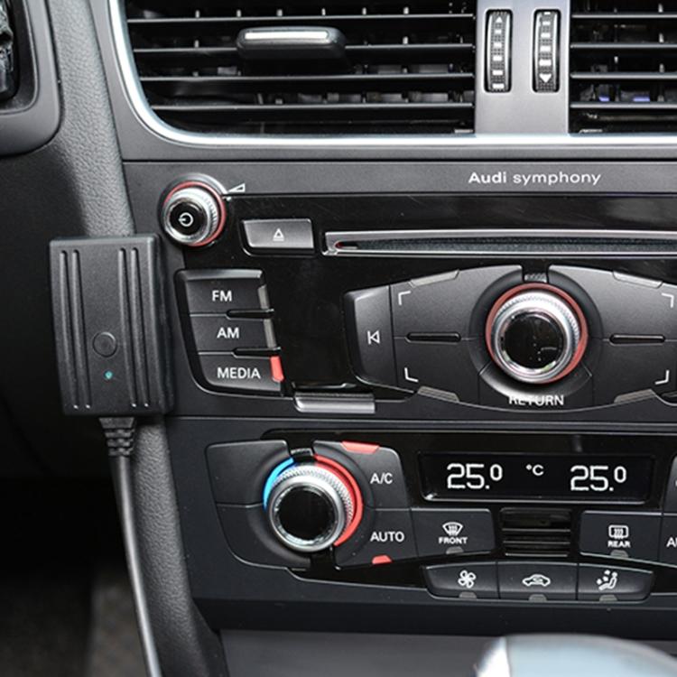 In-car AUX audio adapter cable with microphone module plugged into dashboard near radio controls