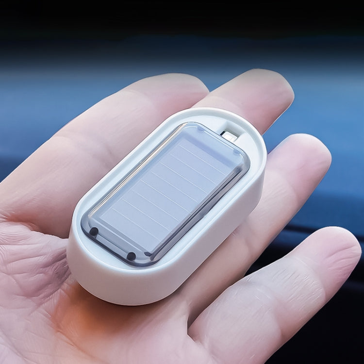 Compact solar LED warning light device in white housing with translucent solar panel