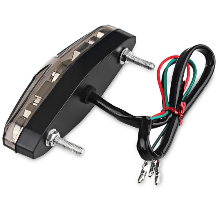 Motorcycle LED running light with black housing, mounting screws, and wiring harness