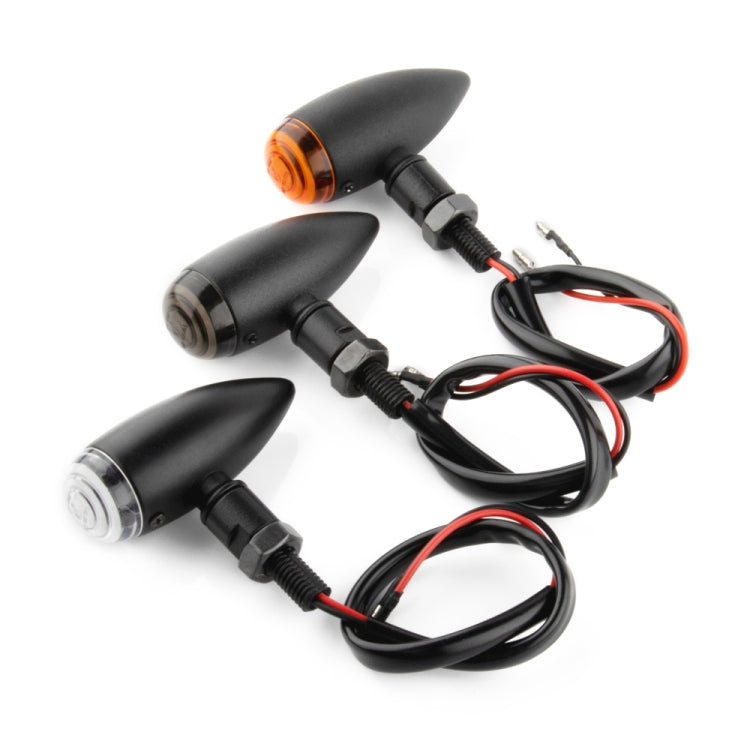Set of motorcycle turn signal lights with amber lenses, black housings, and wiring leads