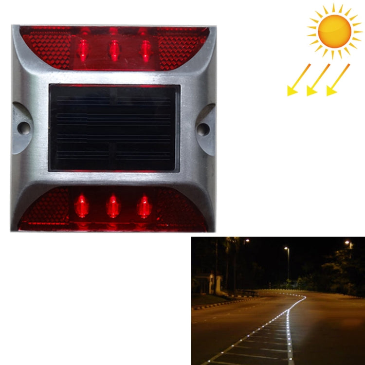 Solar LED road stud light with red flashing lenses and black solar panel window