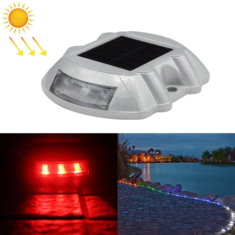 Solar road stud light with red LED glow, solar panel top, horseshoe design.