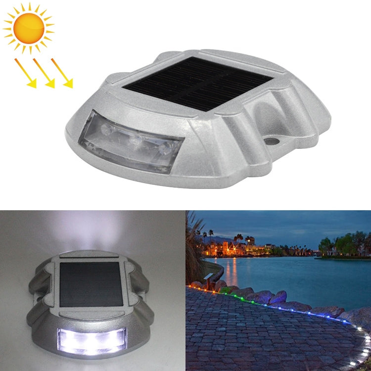Solar road stud light with white LED glow, clear lens housing, horseshoe shape.