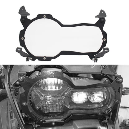 Motorcycle headlight protection cover with black frame, clear lens, and mounting brackets
