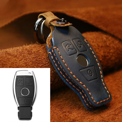 Blue leather key protective cover with metal ring and button icon embossing