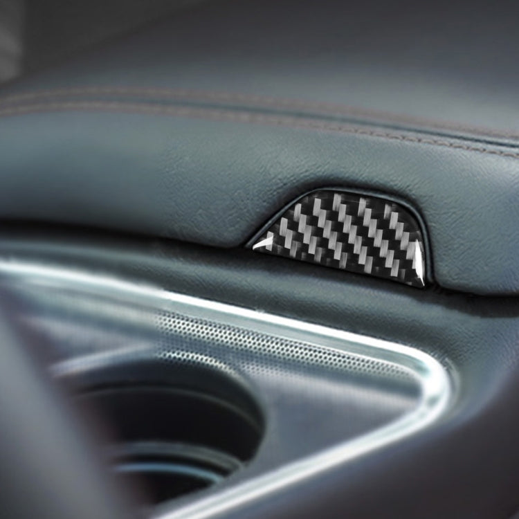 Carbon fiber storage button trim in black center console panel