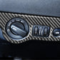 Installed carbon fiber headlight switch panel trim around control knobs on dashboard