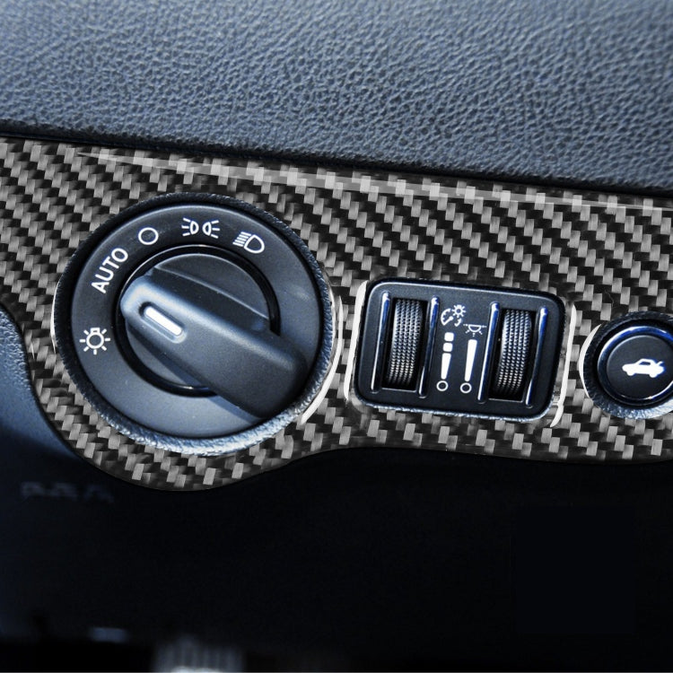 Installed carbon fiber headlight switch panel trim around control knobs on dashboard