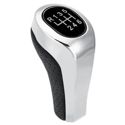 Matte silver 6-speed gear shift knob with black leather grip and black gear indicator panel
