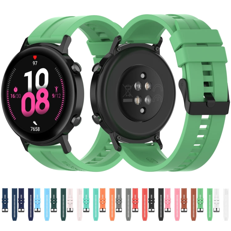 Green silicone watch strap set with black buckles and side button cutouts