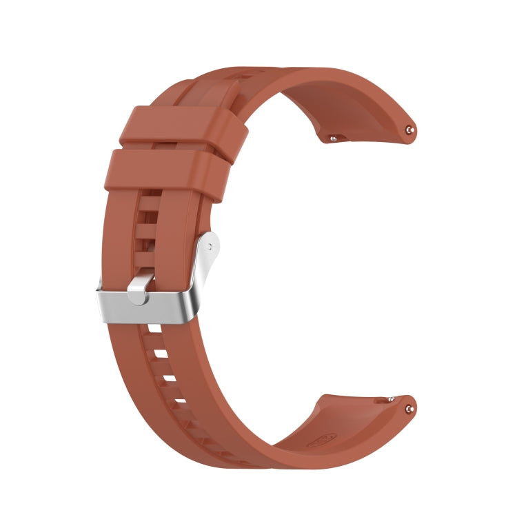 Orange-brown silicone watch strap with silver-tone buckle and adjustable pin holes