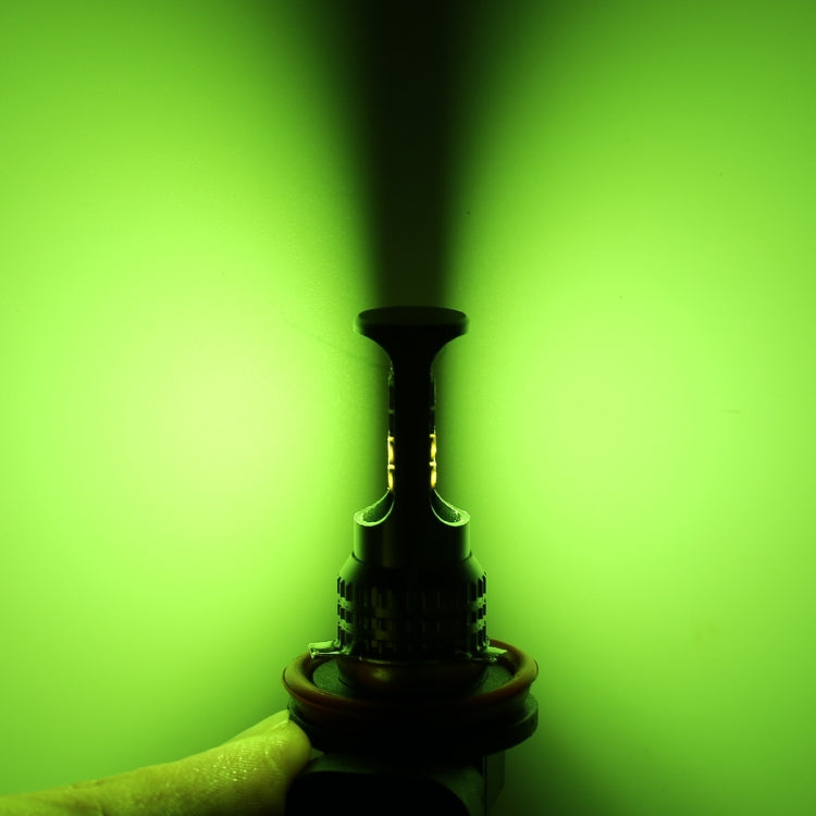 Car LED fog light bulb emitting green light, black base with orange ring