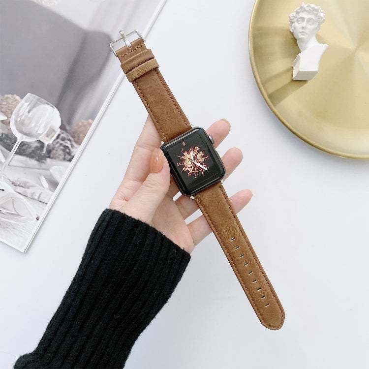 Brown leather watch band with metal buckle and stitched strap holes